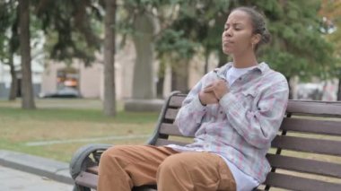 Angry Young African Woman Feeling Frustrated while Sitting Outdoor on Bench