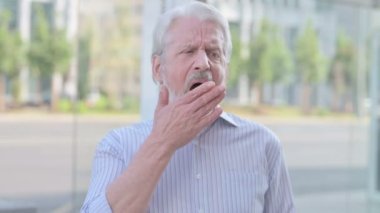 Portrait of Sleepy Senior Old Man Yawning Outdoor