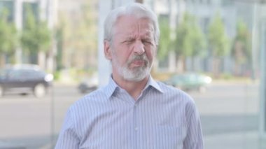 Portrait of Senior Old Man having Toothache Outdoor