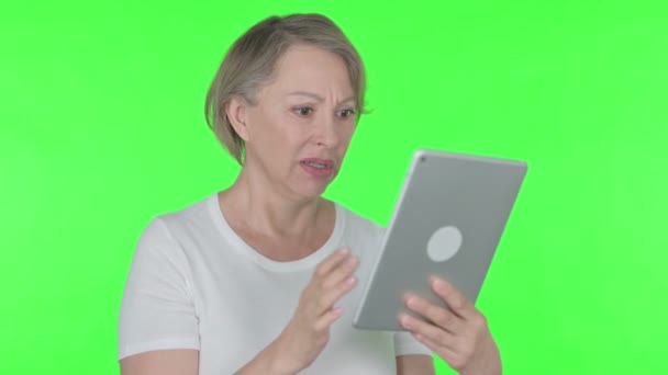 Senior Old Woman Reacting to Loss on Tablet on Green Background 