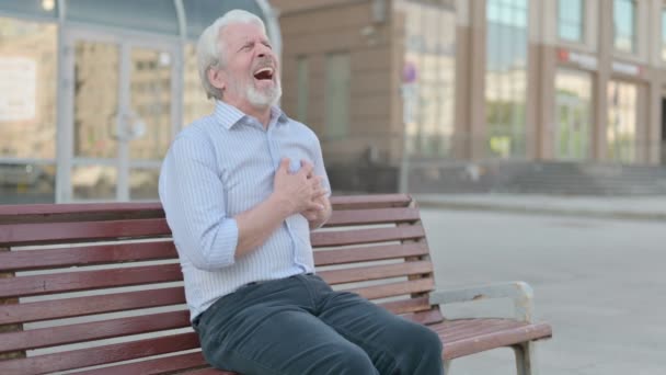 Senior Old Man Having Back Pain While Sitting Bench Outdoor — Stockvideo