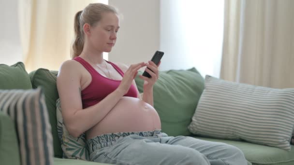 Pregnant Young Woman Using Smartphone Sofa — Video