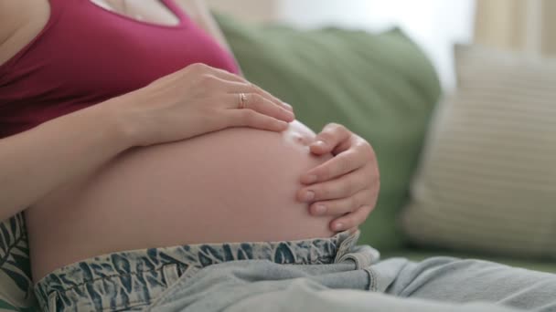 Close Pregnant Young Woman Holding Her Big Belly While Sitting — Stock videók