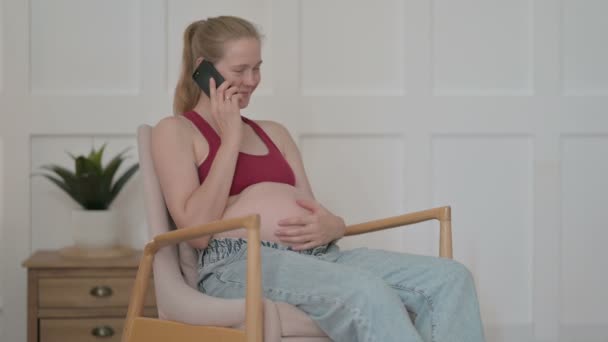 Pregnant Young Woman Talking Phone Home — Stockvideo