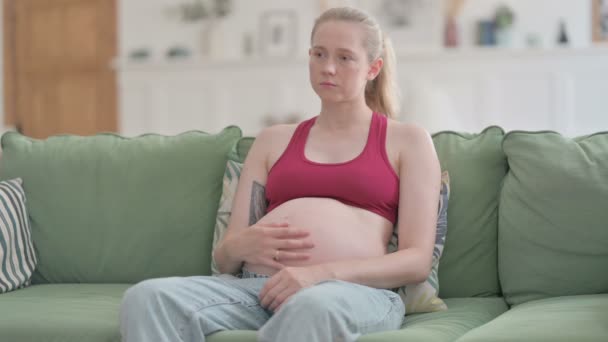 Pensive Pregnant Young Woman Thinking While Sitting Sofa — Video