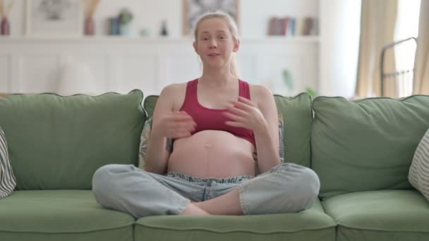 Beautiful Pregnant Young Woman Doing Video Chat While Sitting Sofa — Stockvideo
