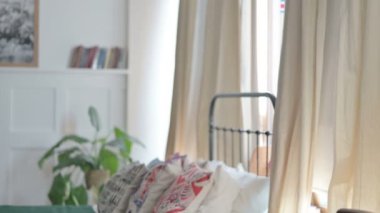 Pregnant Young Woman Holding Her Big Tummy while Standing in Bedroom
