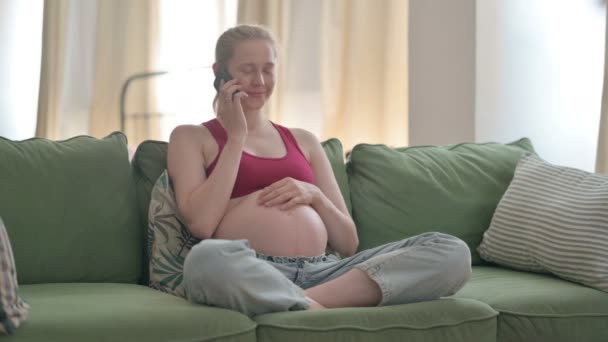 Pregnant Young Woman Talking Phone Home — Stockvideo