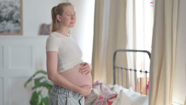 Standing Pregnant Young Woman Smiling Camera While Holding Her Tummy — Stockvideo