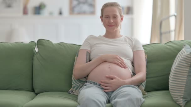 Pregnant Young Woman Smiling While Holding Her Tummy — Video Stock
