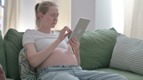 Pregnant Young Woman Using Tablet While Sitting Home — Vídeo de stock