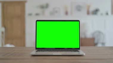 Open Laptop with Green Screen Laying on Desk, Chrome Key