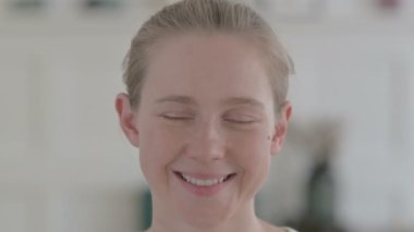 Close Up of Smiling Young Woman Looking at Camera