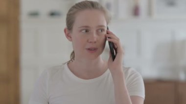 Young Woman Talking on Phone, Discussing and Negotiating 