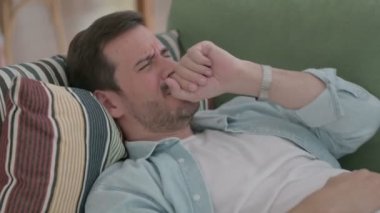 Casual Man Coughing while Sleeping in Bed