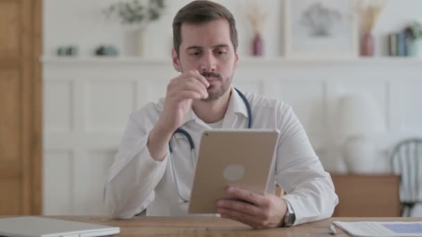 Male Doctor Using Tablet While Sitting Clinic — Video