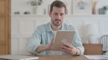 Casual Man Reacting to Loss on Tablet in Office 