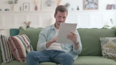 Casual Man Reacting to Loss on Documents, Sofa 