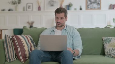Casual Man Working on Laptop on Sofa 
