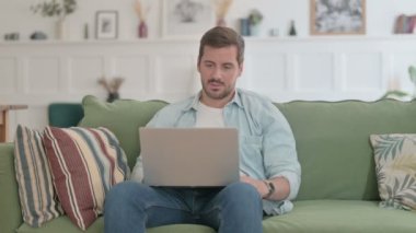 Casual Man with Laptop Coughing on Sofa 