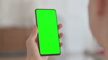 Close Up of Female Hand using Smartphone with Green Chroma Key Screen 