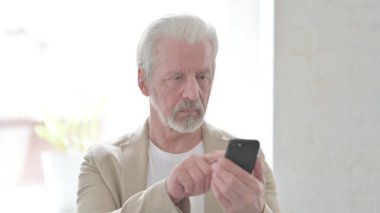 Senior Old Man Browsing Internet on Smartphone