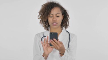 African Lady Doctor Browsing Smartphone on White Background