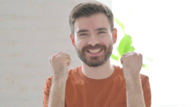 Excited Creative Young Man Reacting to Success