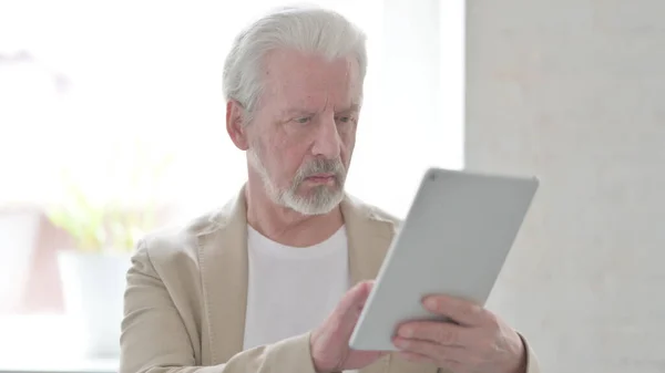 Senior Old Man using Digital Tablet