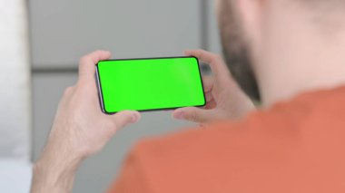 Creative Young Man Watching Smartphone with Chroma Screen