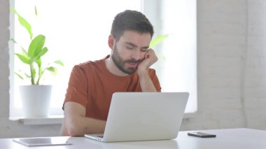 Creative Young Man Sleeping While Sitting in Office