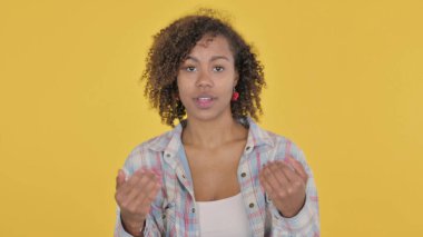 African Woman Pointing at Camera, Inviting on Yellow Background