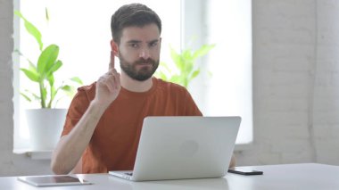 Rejecting Gesture by Creative Young Man at Work