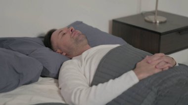 Relaxed Middle Aged Man Sleeping in Bed Peacefully