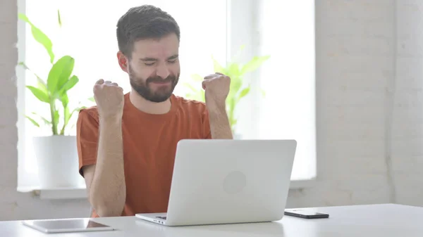 Successful Creative Young Man Celebrating on Laptop