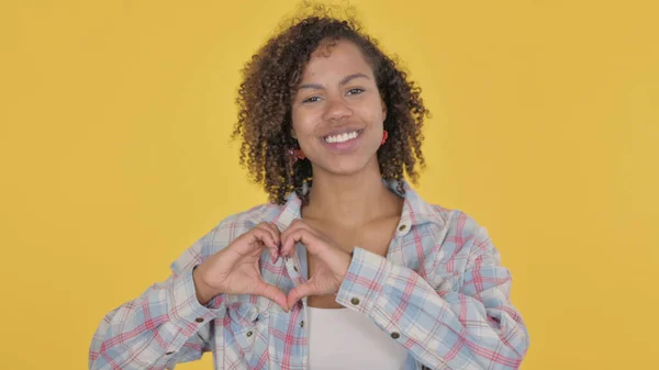 African Woman Showing Heart Shape Hands Yellow Background — Stock fotografie
