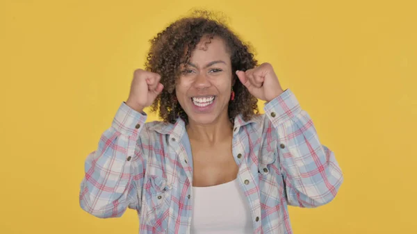 Successful African Woman Celebrating Yellow Background — Stockfoto