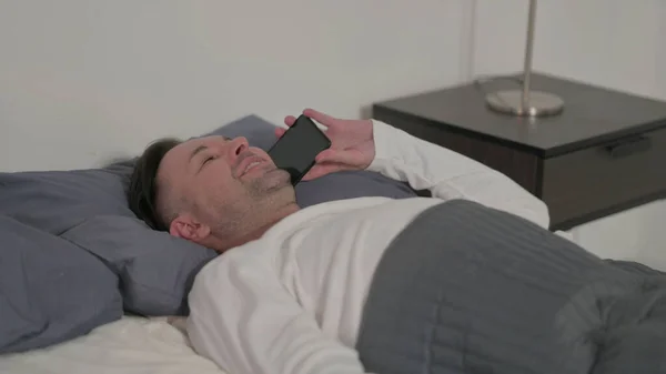 Middle Aged Man Talking Smartphone While Sleeping Bed — Stock fotografie