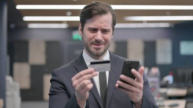 Portrait of Young Businessman Unable to make Online Payment on Smartphone,