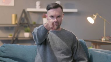 Orta yaşlı adam kamerayı işaret ediyor.