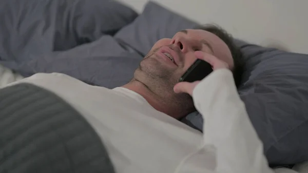 Close Middle Aged Man Talking Smartphone While Laying Bed — Stock fotografie