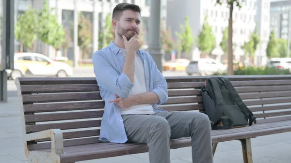 Pensive Man Thinking While Sitting Bench — Zdjęcie stockowe