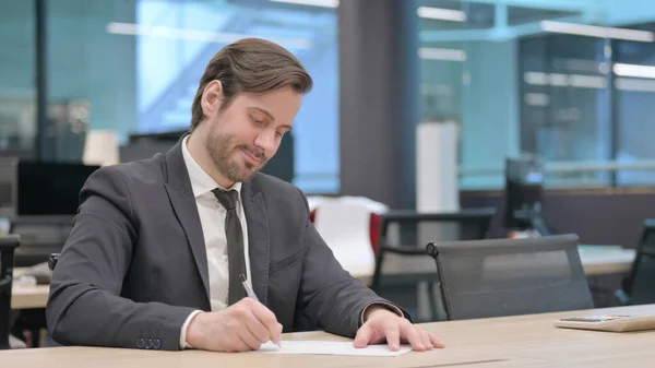 Young Businessman Writing Paper Office Paperwork — Photo