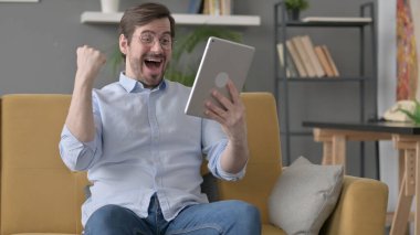 Koltukta Tablet 'te Zaferi Kutlayan Sakallı Genç Adam