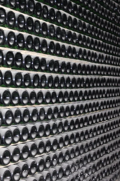 Stacked up wine bottles in the cellar — Stock Photo, Image