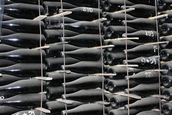 Stacked up wine bottles in the cellar — Stock Photo, Image