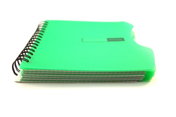 Green notebook on white background Stock Picture