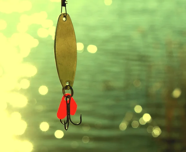 美しいボケ味と水の間の釣りのルアー — ストック写真