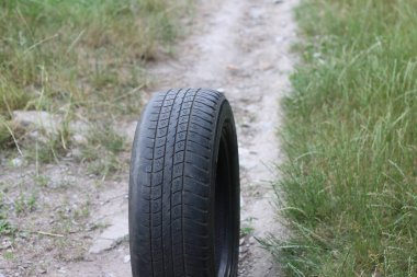 Summer tire on natural background as symbol of need to replace winter tires with new summer tires or used summer tires