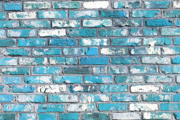 Brick wall with unusual blue bricks made of whole blue bricks and broken blue bricks for an abstract blue background